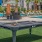 an outside pool table near the pool