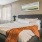 a bed in a large room with a large window