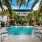 a pool with palm trees around it