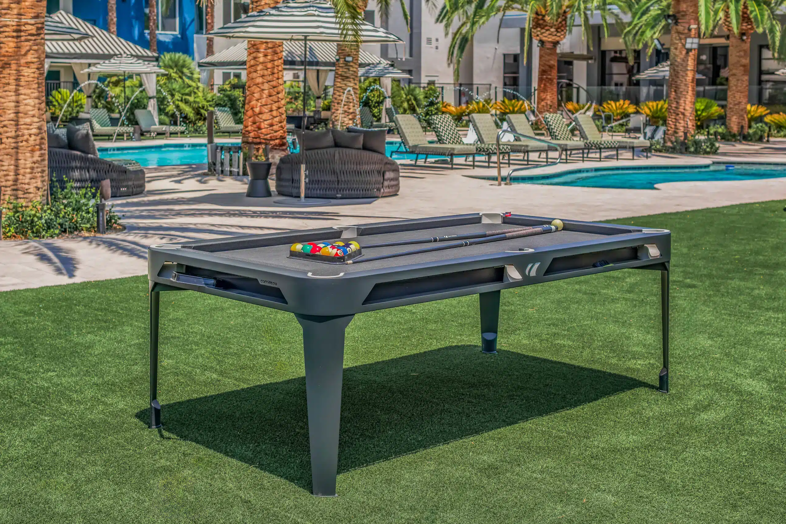 billiards table outside by a pool