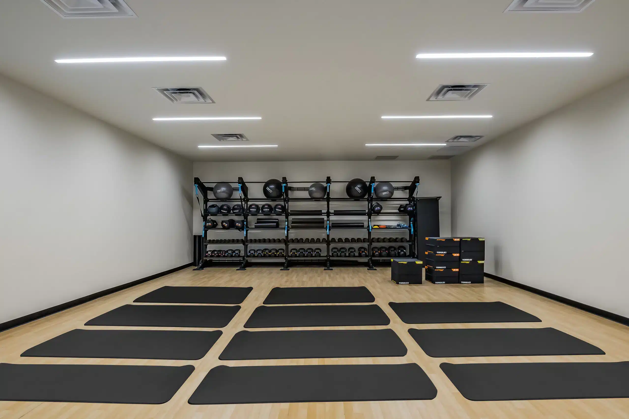 Yoga studio with weights on shelves