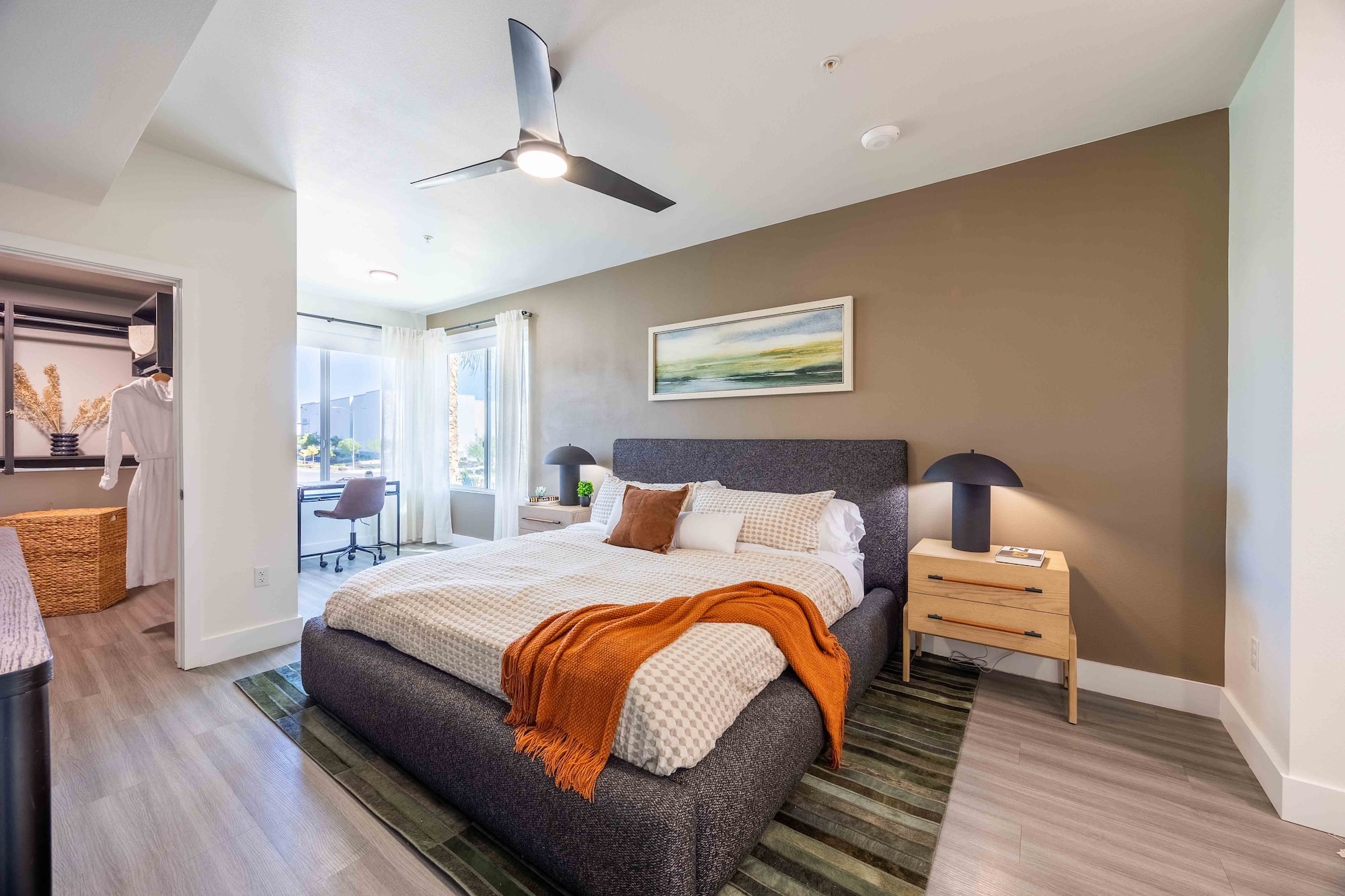 open bedroom with ceiling fan and natural light