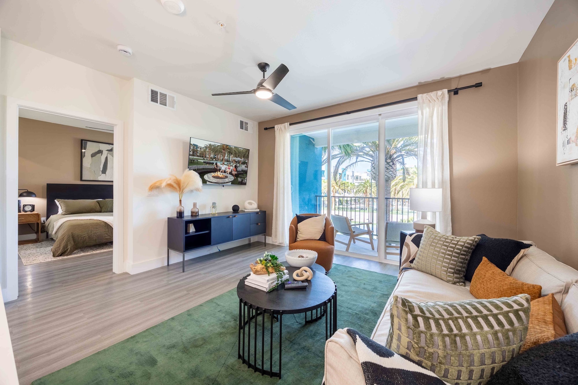 living room with sliding glass doors that open to a balcony