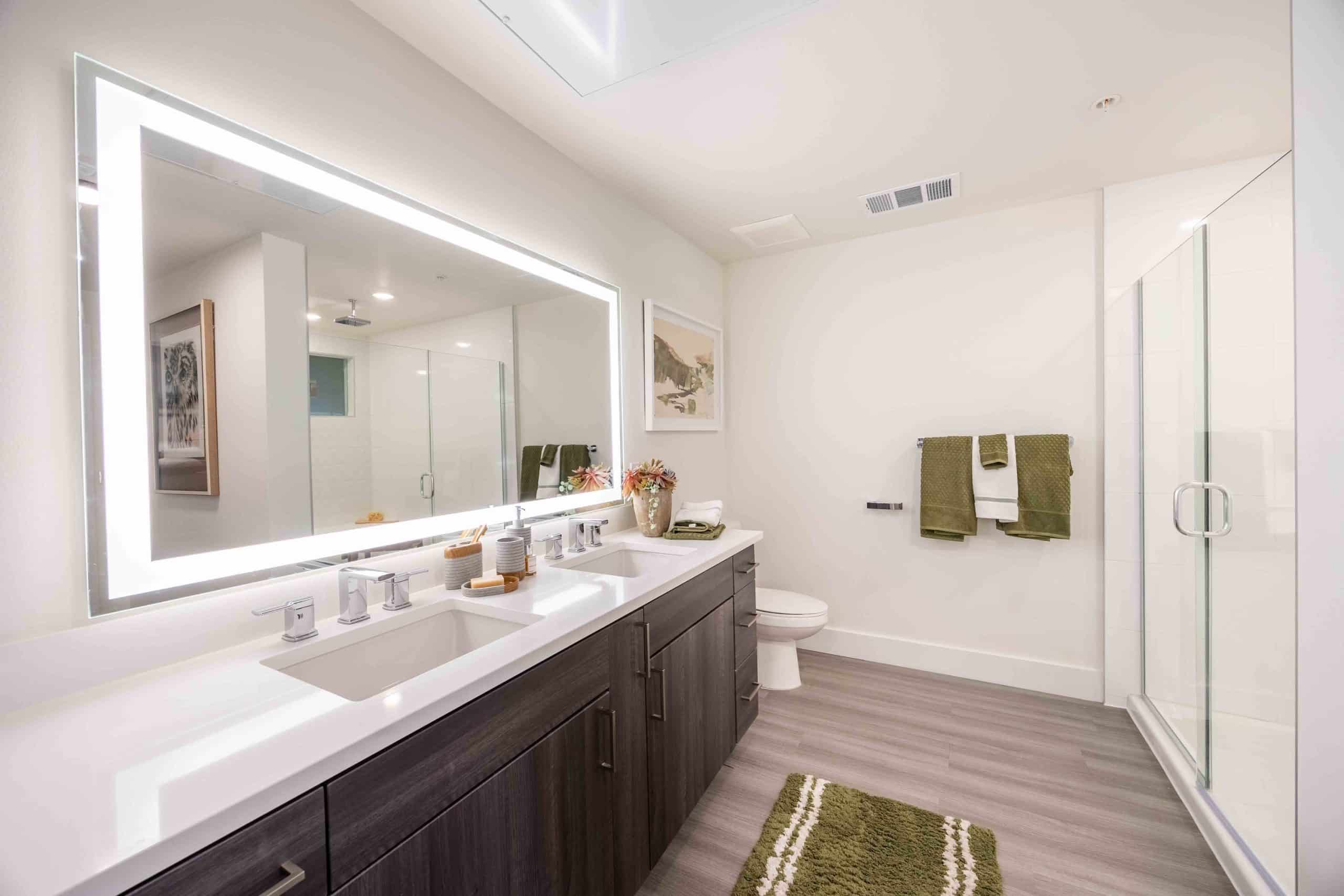 bathroom with two sinks and shower