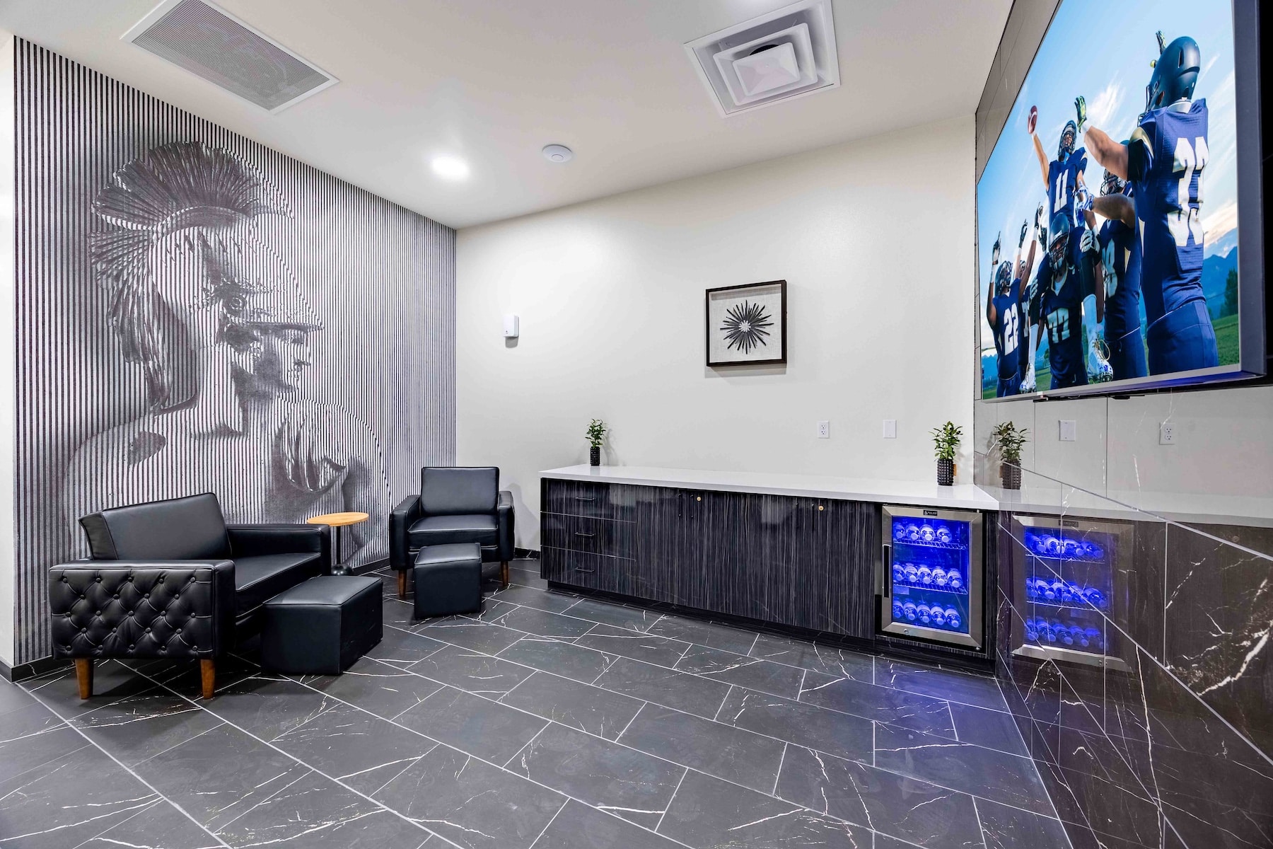 football on tv in a game room with mini fridge